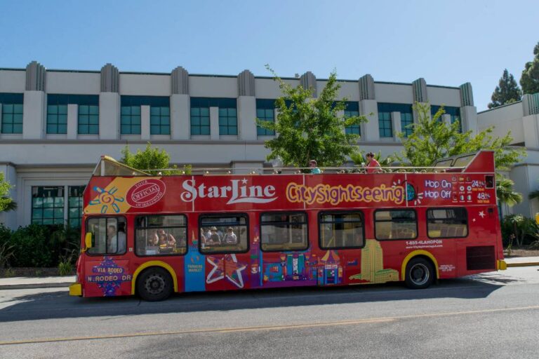 A hop-on hop-off Los Angeles sightseeing bus driving down the street.