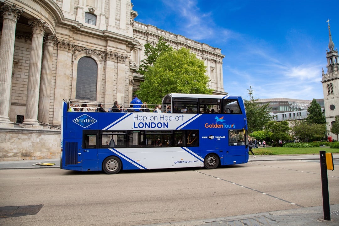 A London Bus Tour driving through the streets.