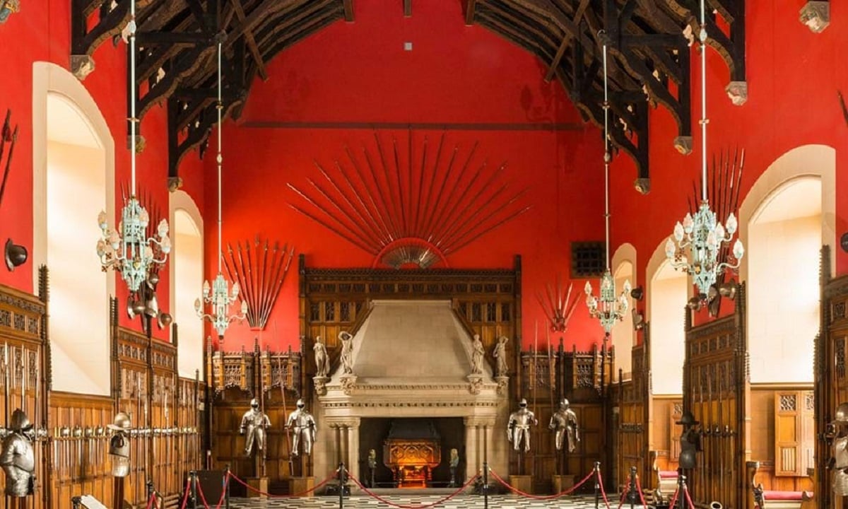 An Edinburgh Castle interior showing many suits of armor and a fireplace.