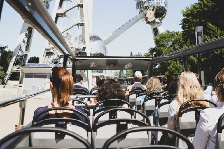 A Brussels bus tour driving past the Atomium.