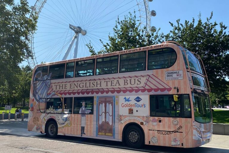 A photo of the Afternoon Tea Bus driving past the London Eye.