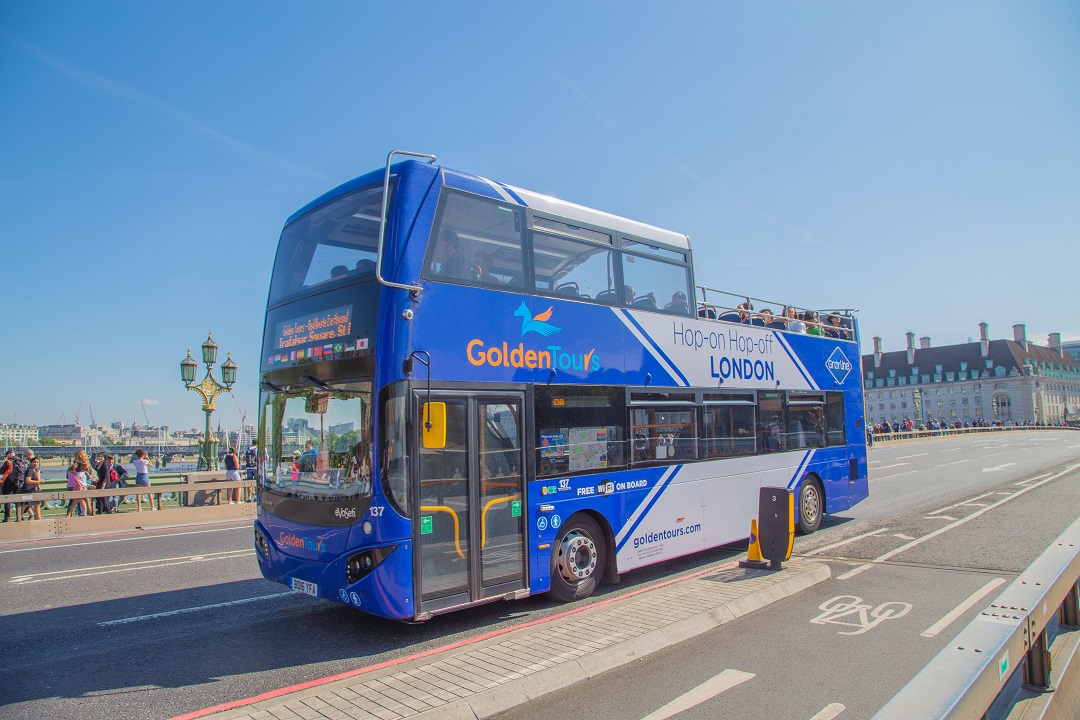 A photo of a London Hop-On Hop-Off bus Tour driving.