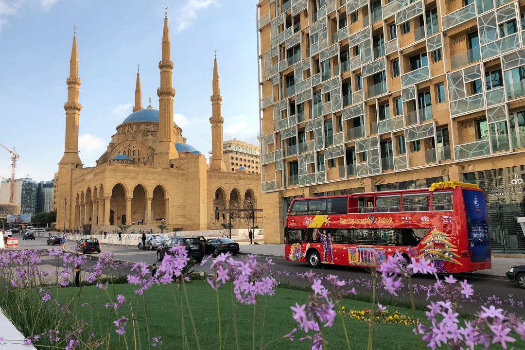 A photo showing a Beirut bus tour driving past the Mohammad Al Amin Mosque.