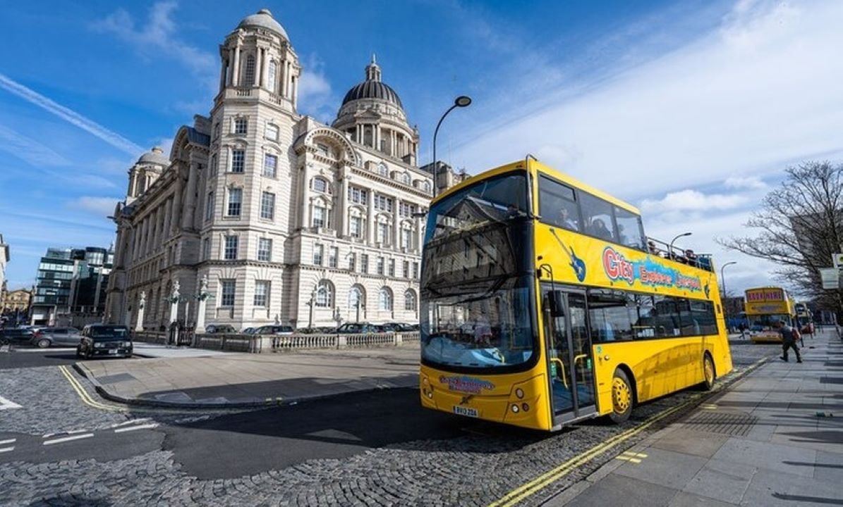 A Liverpool tour bus in front of the Port of Liverpool building.