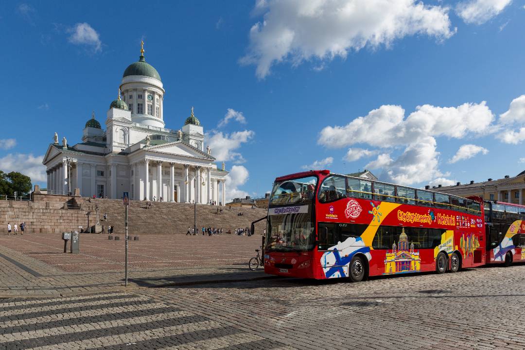 A Helsinki hop-on hop-off bus tour passing by Helsinki Cathedral.