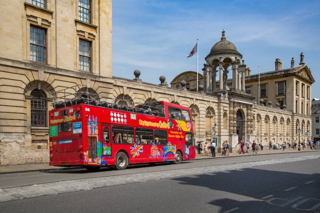 An Oxford bus tour passing the Queen's College.