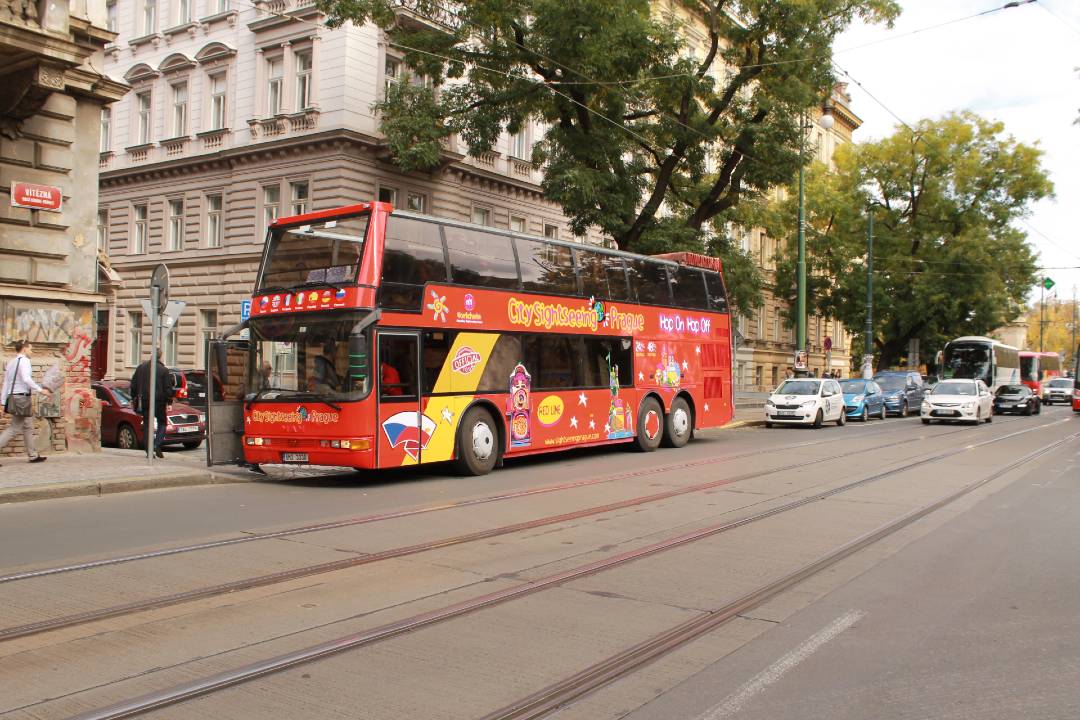 A photo of a Prague bus tour driving down the street.