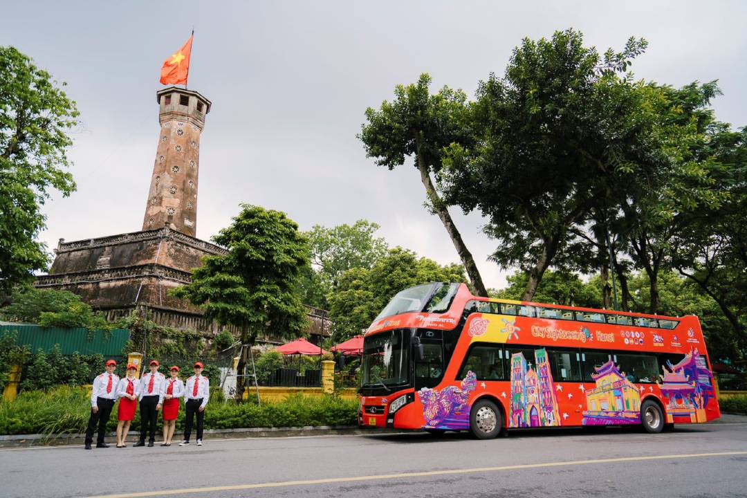 A Hanoi bus tour in front of the Hanoi Flagtower.