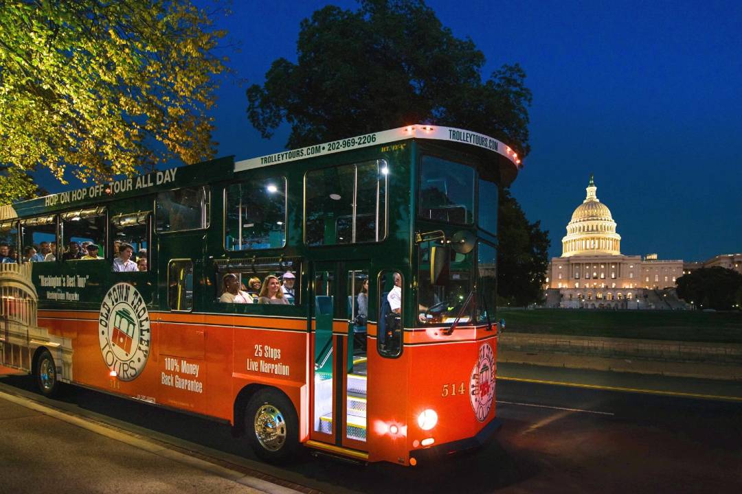 A photo of a bus tour passing the Capitol.