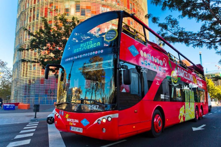 A bus tour driving in Barcelona.