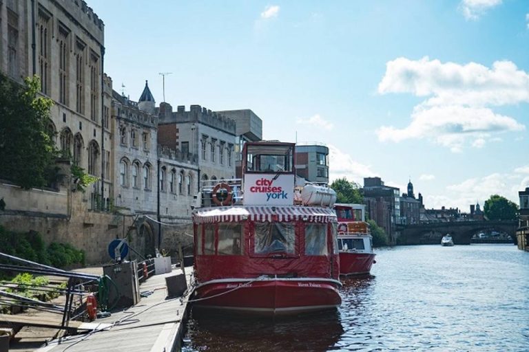 A photo of a York city cruise by a dock.