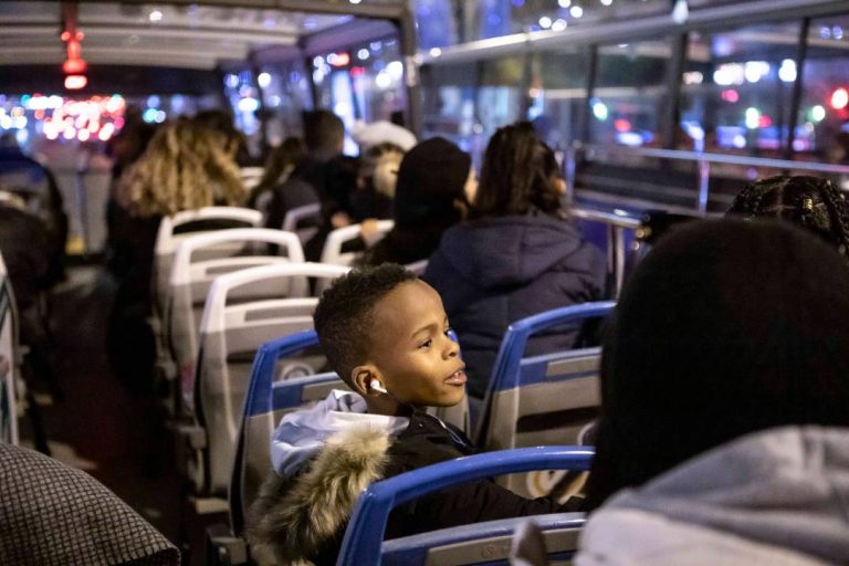 A photo of a child on a bus tour.
