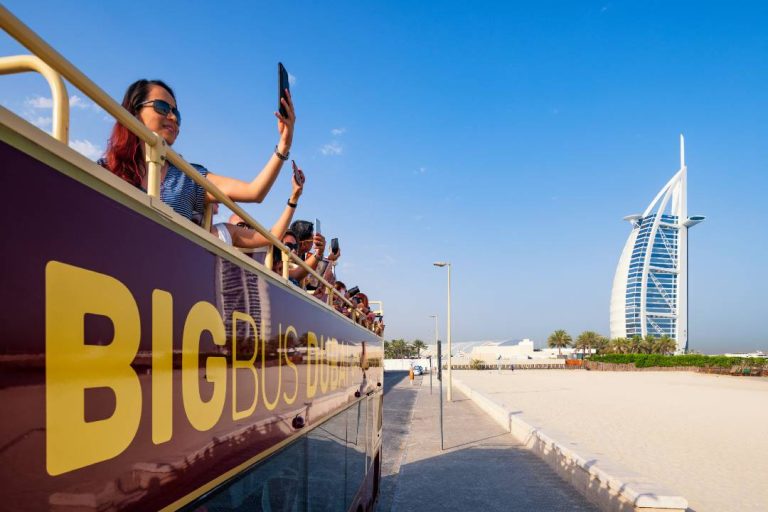 A photo of a Dubai Bus Tour driving towards the Burj Al Arab.