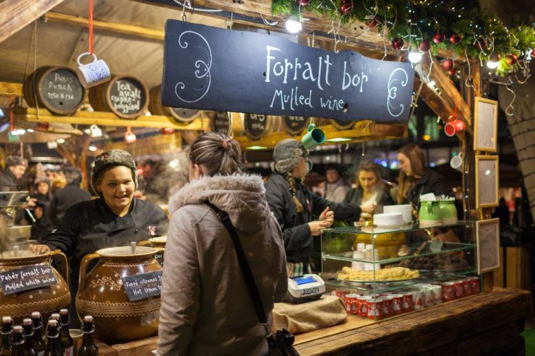 A photo of a person at a Christmas stall.