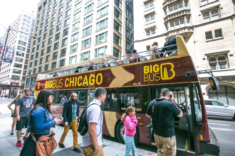 A photo of people getting on a Chicago bus tour.