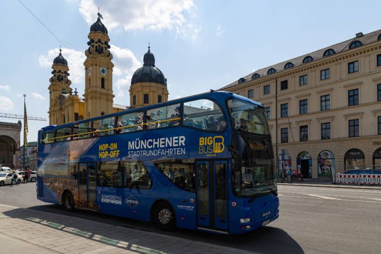 A photo of a Munich bus tour passing Theatine Church.