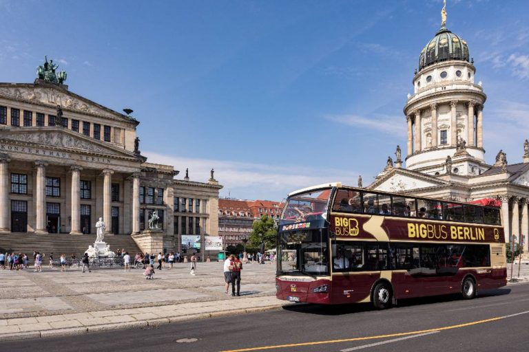 A photo of an open-top Berlin bus tour near the Konzerthaus concert hall.