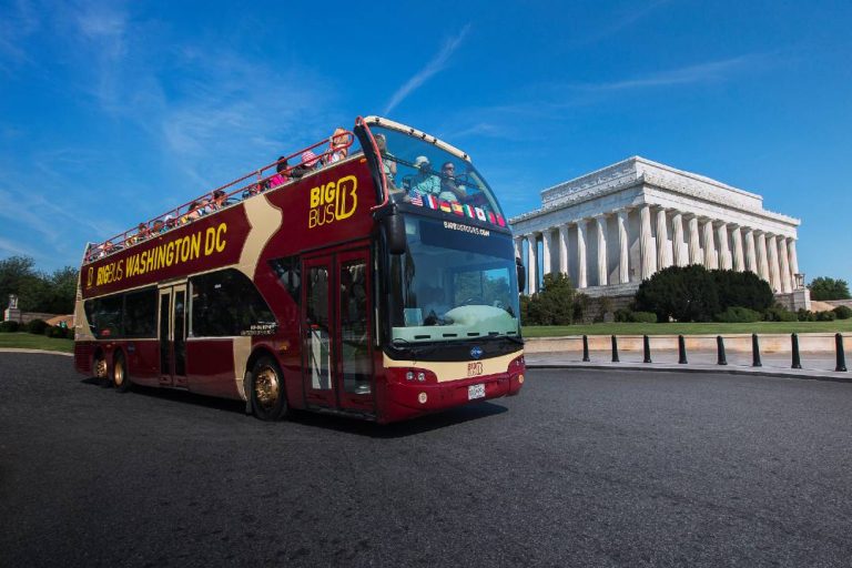 A photo of a Washington DC Hop-On Hop-Off Bus tour passing by the Lincoln Memorial.